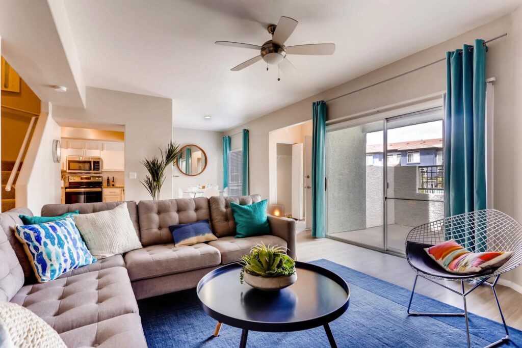 Modern living room with view of patio at Verano Townhomes in Phoenix.