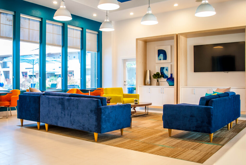Common area with lounge seating and TV at Verano townhomes in Phoenix for rent