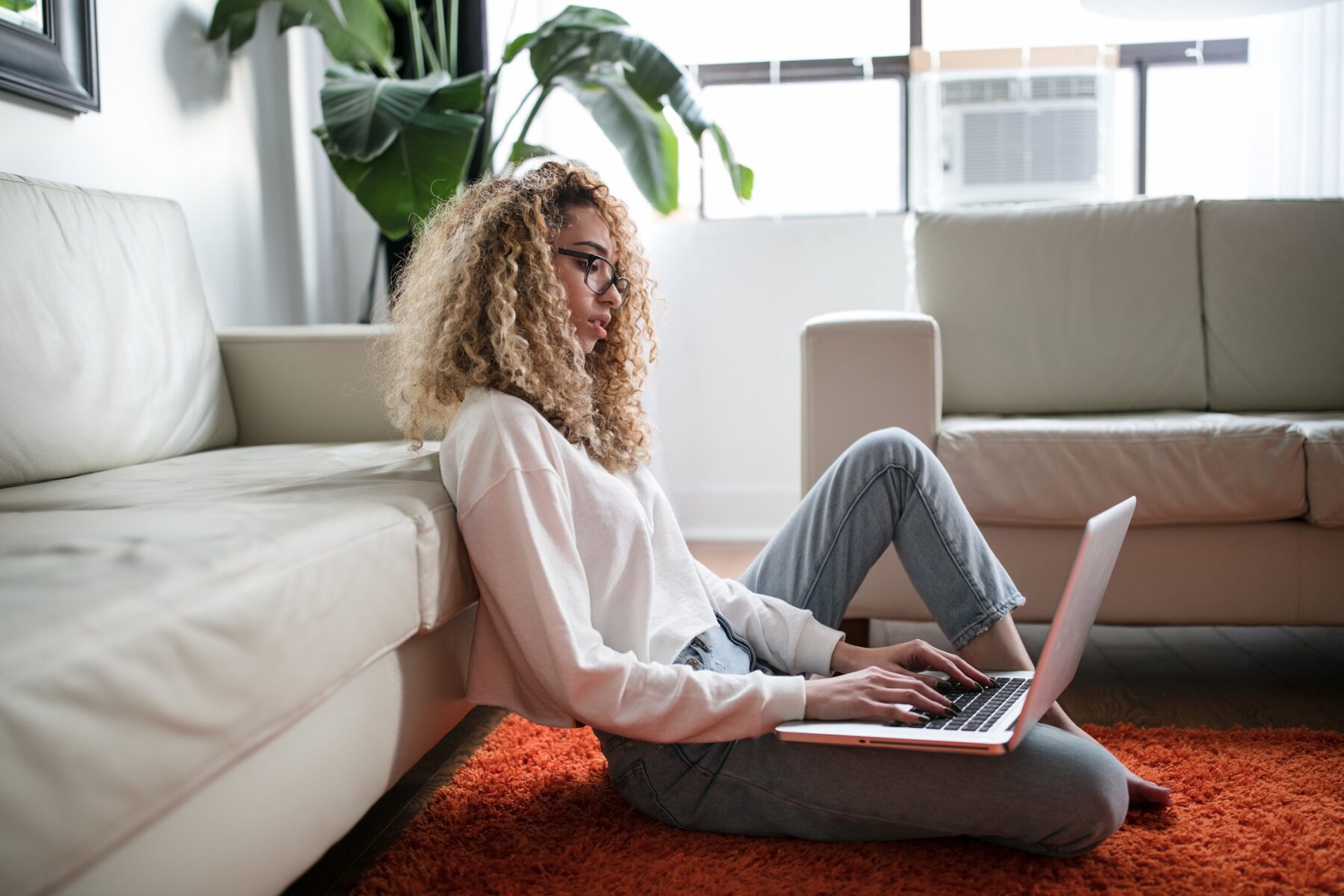 Woman sitting on the floor using a laptop